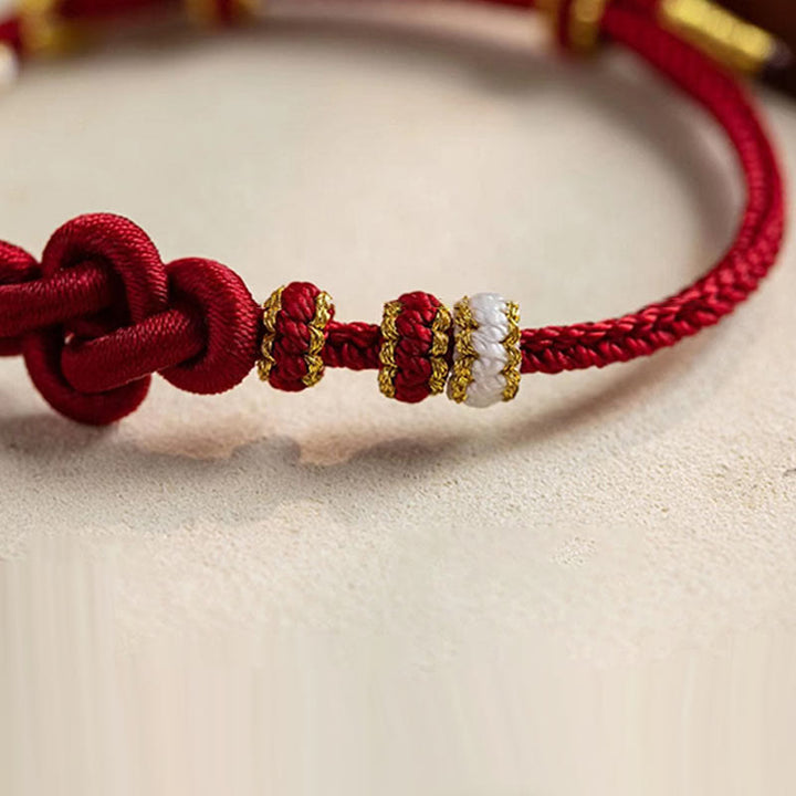 Pulsera de cuerda de la suerte con dije de flor de melocotón, nudo de amor verdadero hecho a mano con Buddha Stones