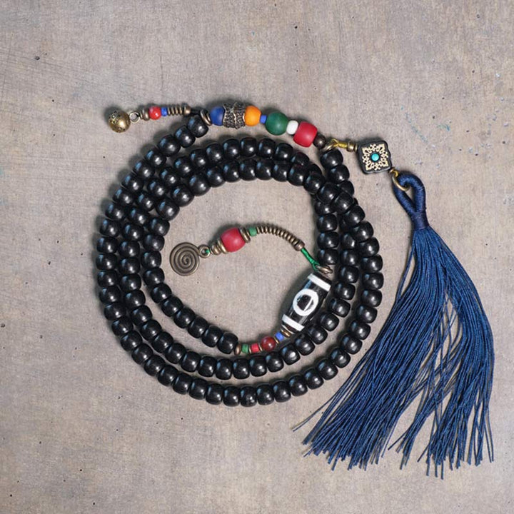 Buddha Stones 108 cuentas Mala madera de ébano cuentas Dzi cobre equilibrio borla pulsera