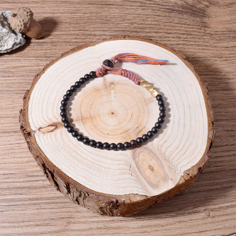 Pulsera con borlas de ónix negro tibetano hecha a mano con Buddha Stones