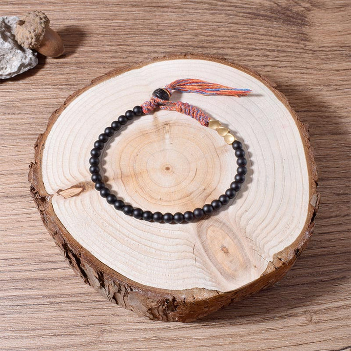 Pulsera con borlas de ónix negro tibetano hecha a mano con Buddha Stones