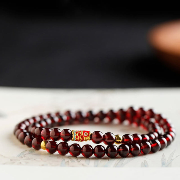 Pulsera de protección con granate natural y pez Koi de oro 999 de Buddha Stones - image 17
