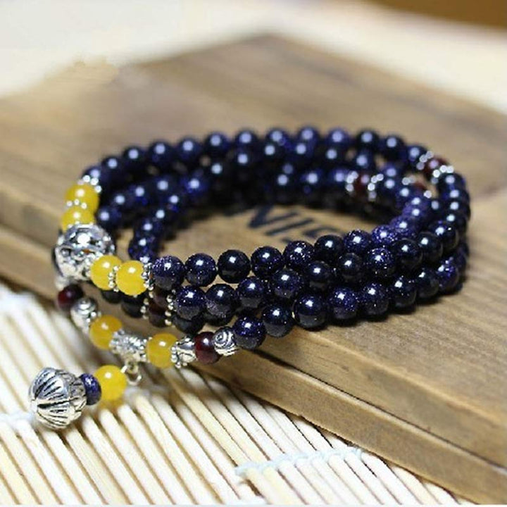 Pulsera con dijes de riqueza de arenisca azul con Buddha Stones Mala