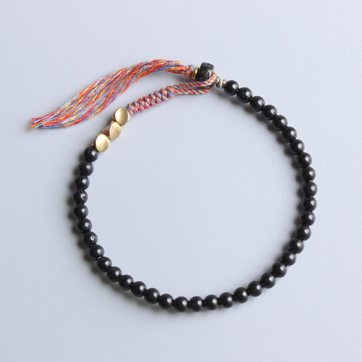 Pulsera con borlas de ónix negro tibetano hecha a mano con Buddha Stones