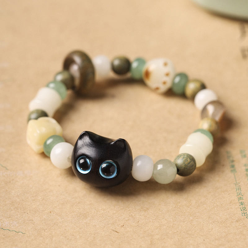 Buddha Stones, semillas de Bodhi, sándalo verde, madera de ébano, hoja pequeña, sándalo rojo, cabeza de gato, garra de pata, pulsera de la paz - Gato de madera de ébano (ojos azules) (circunferencia de muñeca: 14-16 cm) - image 1
