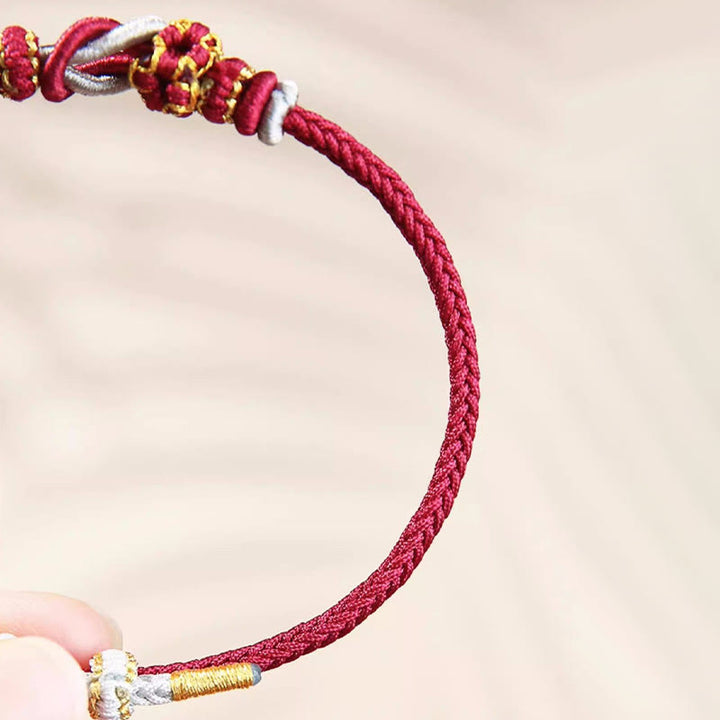 Pulsera de protección de la suerte con nudo de paz de ocho hilos con nudo de flor de melocotón hecho a mano con Buddha Stones