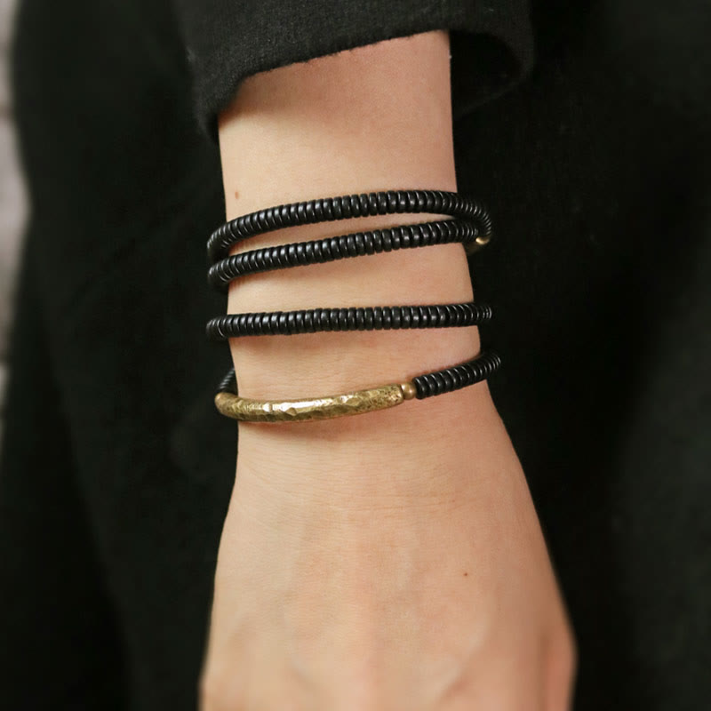 Pulsera multicapa con equilibrio de cobre y madera de ébano con Buddha Stones