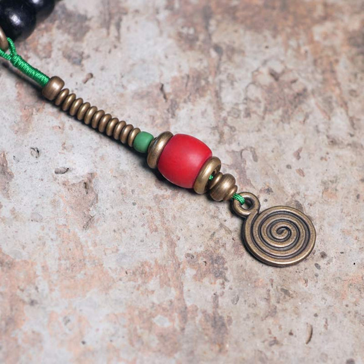 Buddha Stones 108 cuentas Mala madera de ébano cuentas Dzi cobre equilibrio borla pulsera