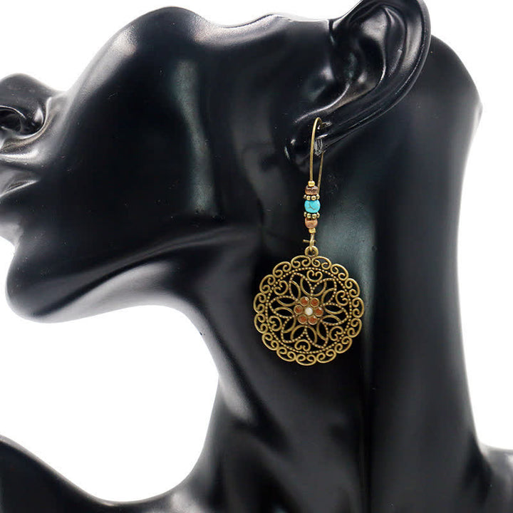 Pendientes colgantes redondos de la suerte con diseño de flores