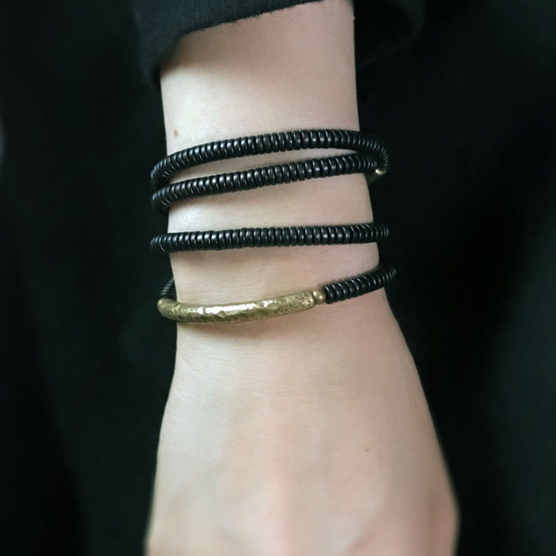 Pulsera multicapa con equilibrio de cobre y madera de ébano con Buddha Stones