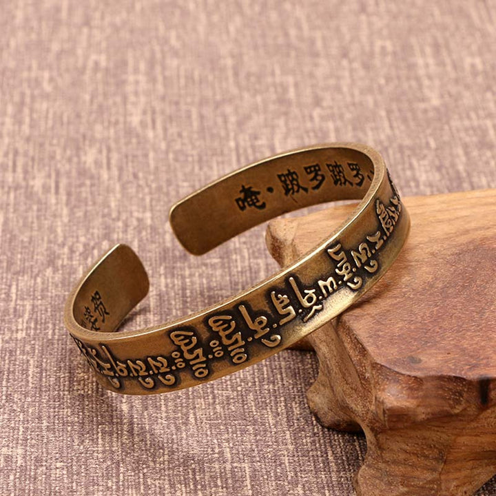 Buddha Stones Pulsera de curación de latón y cobre con mantra tibetano Mahāpratisarā en sánscrito