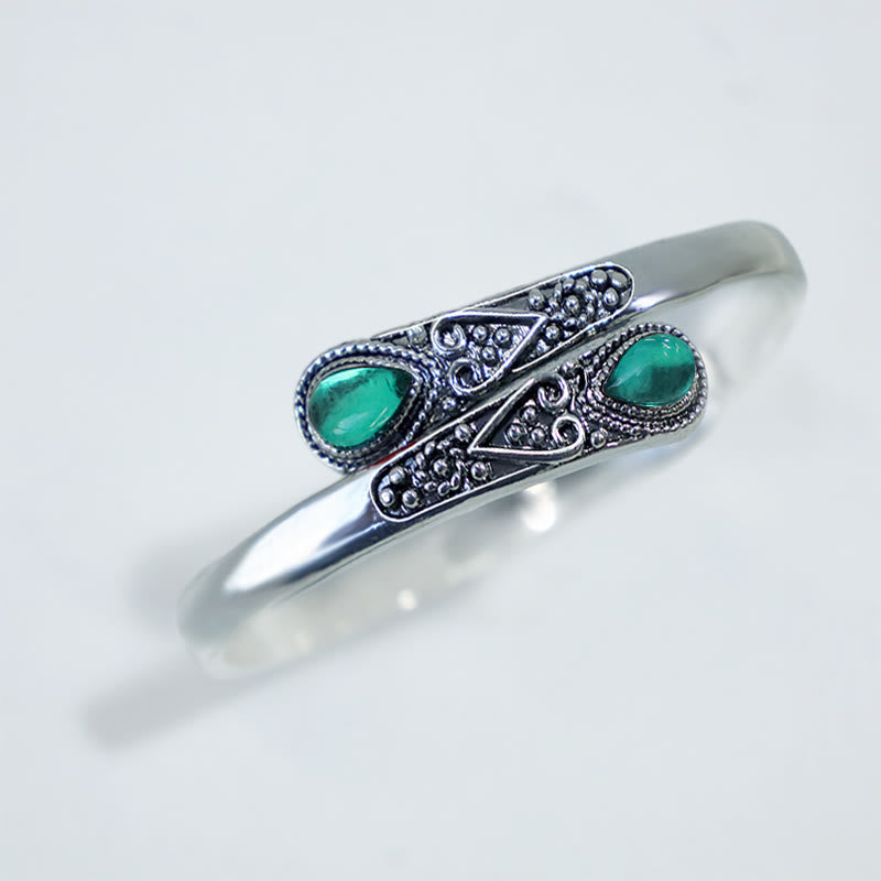 Brazalete de pulsera curativo con patrón de gota de agua de circonita con Buddha Stones