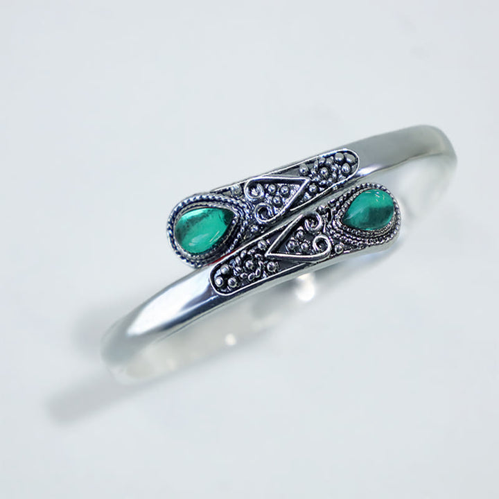 Brazalete de pulsera curativo con patrón de gota de agua de circonita con Buddha Stones