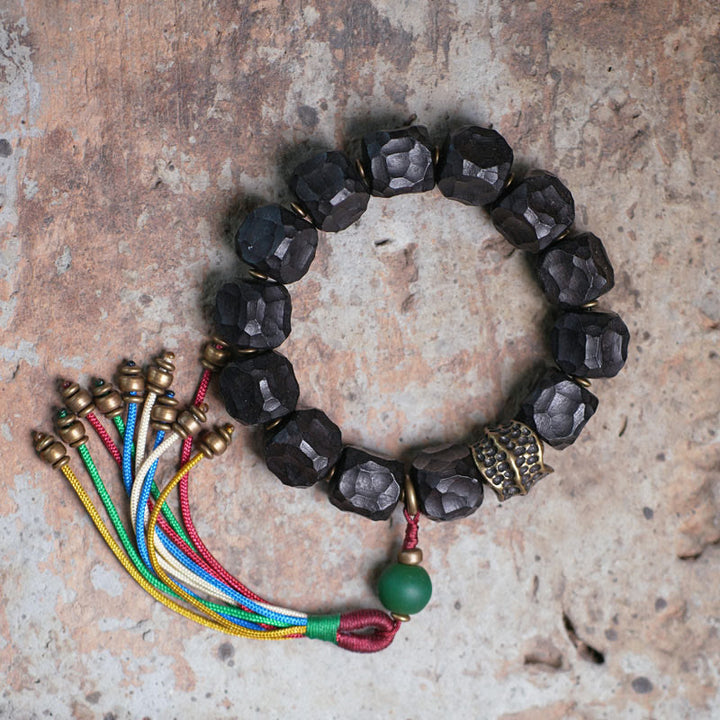 Pulsera Mala de muñeca con borla de paz de cobre y madera de ébano del Tíbet