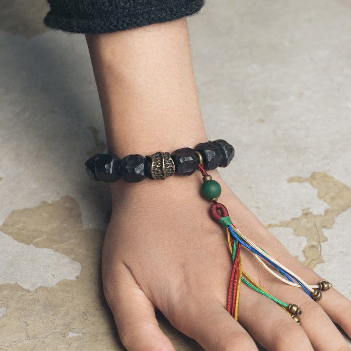 Pulsera Mala de muñeca con borla de paz de cobre y madera de ébano del Tíbet
