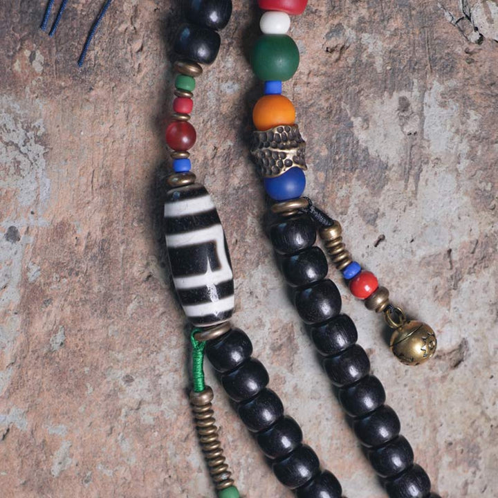 Buddha Stones 108 cuentas Mala madera de ébano cuentas Dzi cobre equilibrio borla pulsera