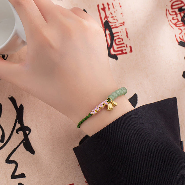 Pulsera trenzada de la suerte con dije de lirio de los valles y cuentas de jade hechas a mano con Buddha Stones