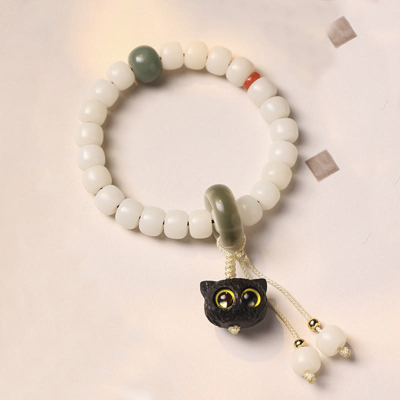 Pulsera de armonía de paz con dije de gato encantador de madera negra africana con semillas de Bodhi naturales de Buddha Stones - Semilla Bodhi de Gato de Ojos Amarillos - image 1