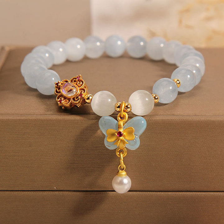 Pulsera con dije de perlas y mariposas curativas con ojo de gato, aguamarina y Buddha Stones