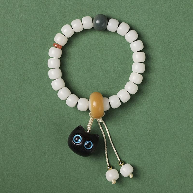 Pulsera de armonía de paz con dije de gato encantador de madera negra africana con semillas de Bodhi naturales de Buddha Stones - Semilla Bodhi de gato de ojos azules - image 6