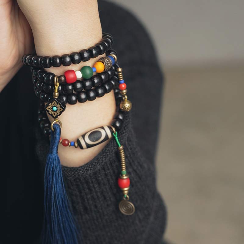 Buddha Stones 108 cuentas Mala madera de ébano cuentas Dzi cobre equilibrio borla pulsera