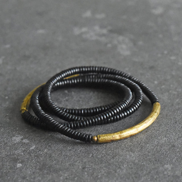 Pulsera multicapa con equilibrio de cobre y madera de ébano con Buddha Stones