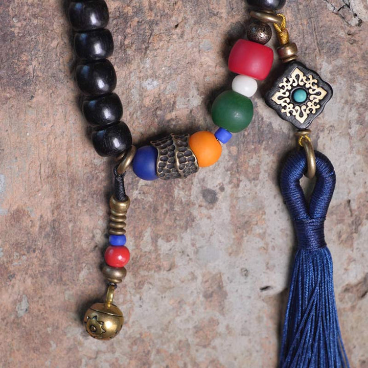 Buddha Stones 108 cuentas Mala madera de ébano cuentas Dzi cobre equilibrio borla pulsera