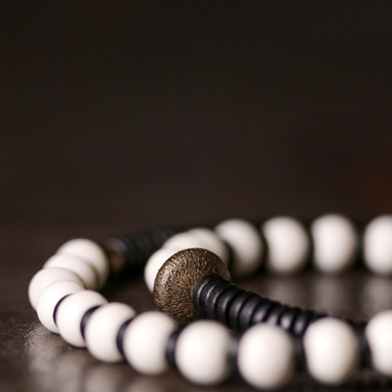 Pulsera de pareja con Buddha Stones, cuentas de hueso, madera de ébano y cobre.