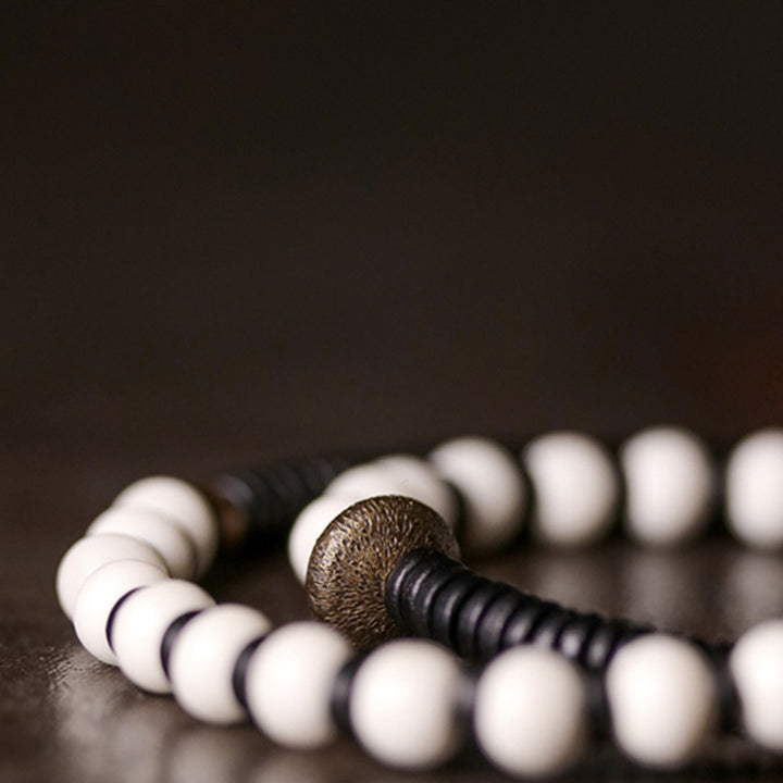 Pulsera de pareja con Buddha Stones, cuentas de hueso, madera de ébano y cobre.