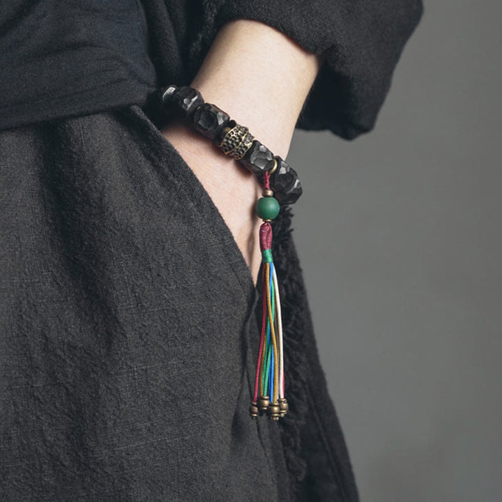 Pulsera Mala de muñeca con borla de paz de cobre y madera de ébano del Tíbet