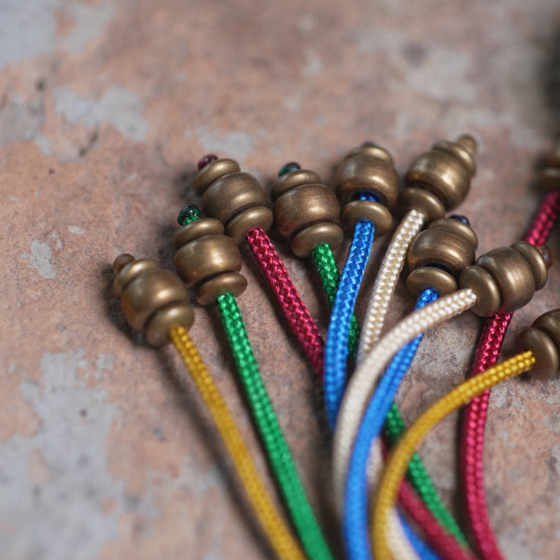 Pulsera Mala de muñeca con borla de paz de cobre y madera de ébano del Tíbet