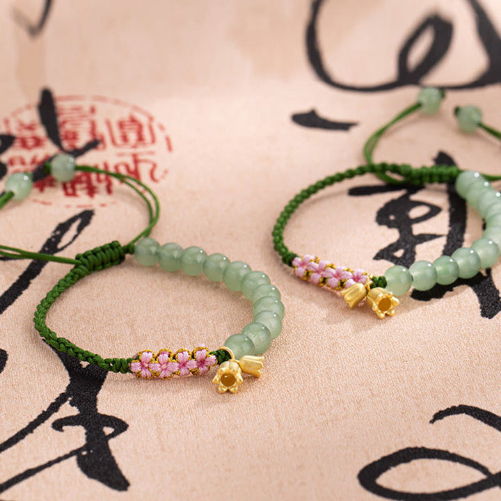 Pulsera trenzada de la suerte con dije de lirio de los valles y cuentas de jade hechas a mano con Buddha Stones