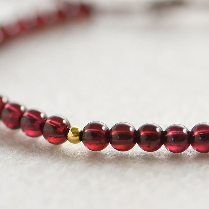 Pulsera de estabilidad con cuentas doradas y granate natural con Buddha Stones