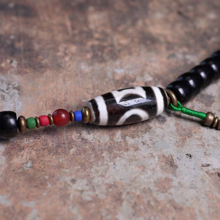 Buddha Stones 108 cuentas Mala madera de ébano cuentas Dzi cobre equilibrio borla pulsera