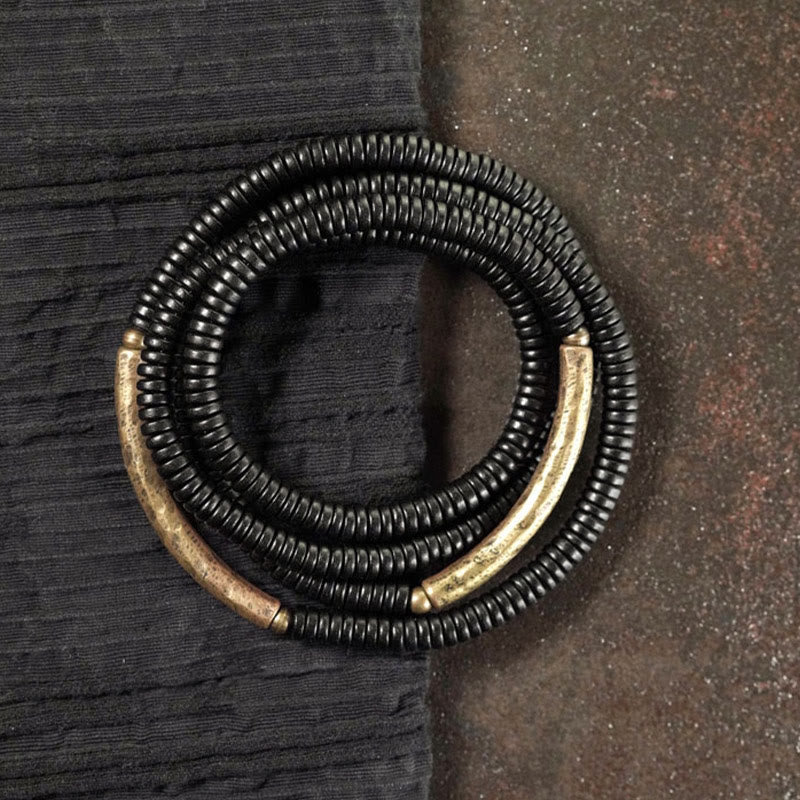 Pulsera multicapa con equilibrio de cobre y madera de ébano con Buddha Stones