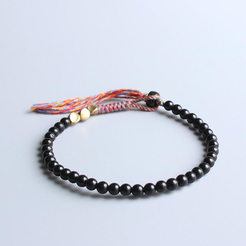 Pulsera con borlas de ónix negro tibetano hecha a mano con Buddha Stones