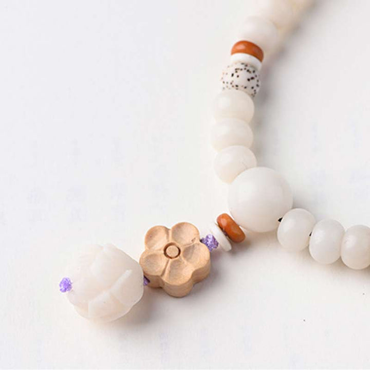 Pulsera de bendición de loto Bodhi de jade blanco tibetano con Buddha Stones