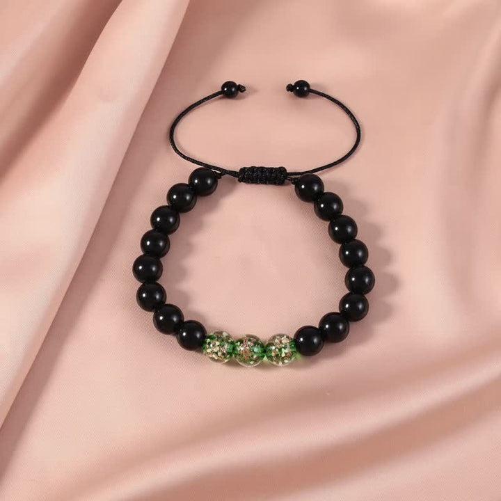 Pulsera de fuerza con piedra luminosa luminosa de obsidiana negra de Buddha Stones