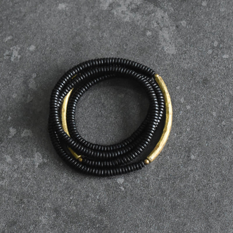 Pulsera multicapa con equilibrio de cobre y madera de ébano con Buddha Stones