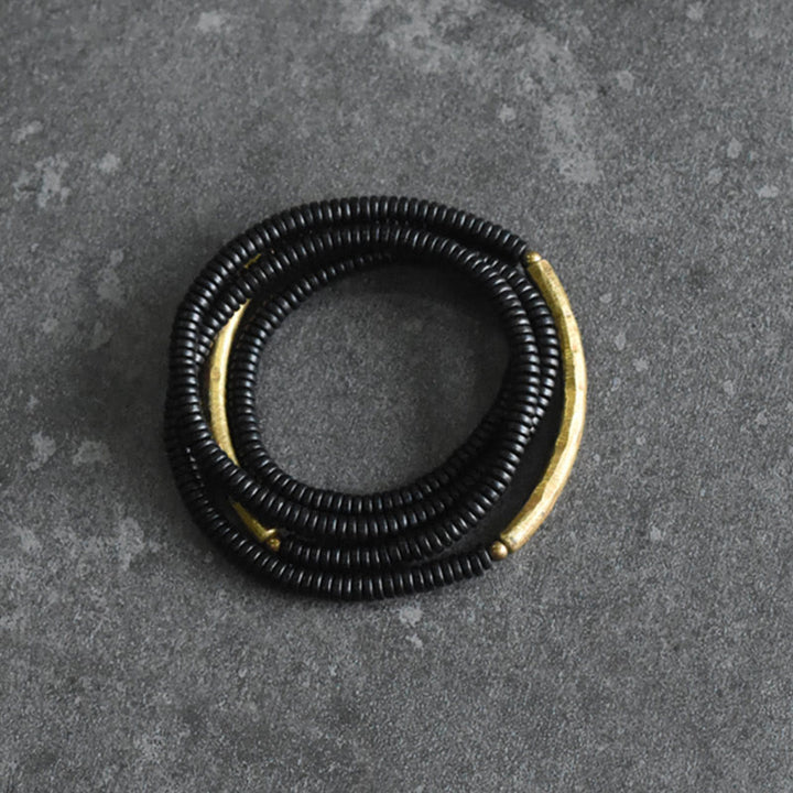 Pulsera multicapa con equilibrio de cobre y madera de ébano con Buddha Stones