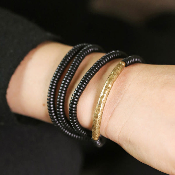Pulsera multicapa con equilibrio de cobre y madera de ébano con Buddha Stones