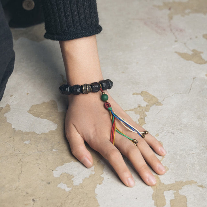 Pulsera Mala de muñeca con borla de paz de cobre y madera de ébano del Tíbet
