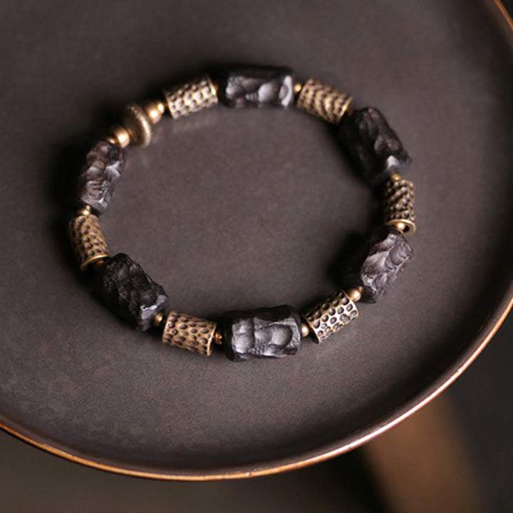 Pulsera de paz tranquila de cobre y madera de ébano tibetano con Buddha Stones
