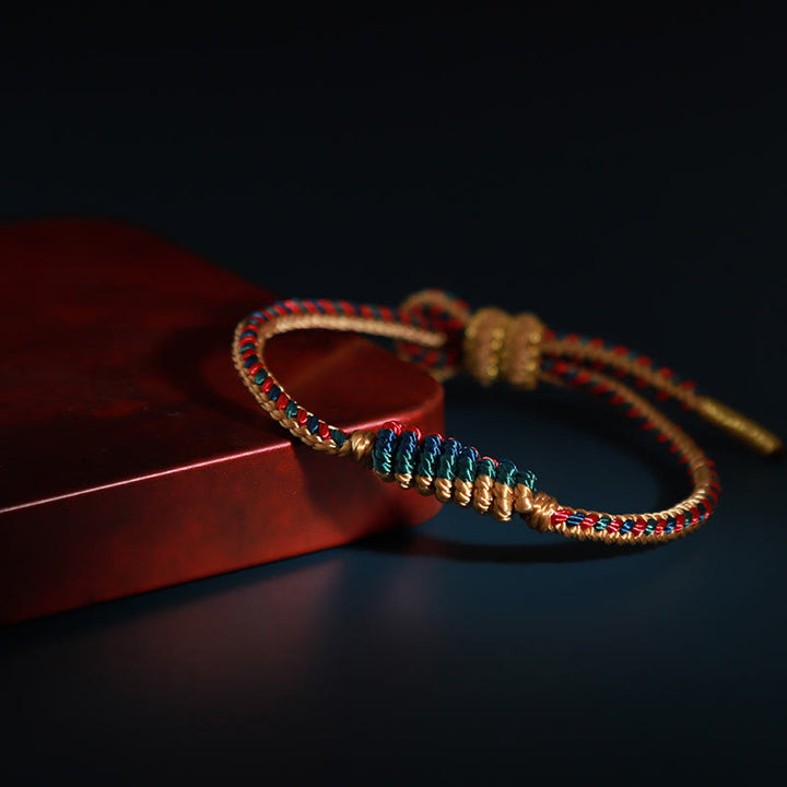 Pulsera de protección trenzada con rueda de oración, nudo de la paz, hecho a mano, con Buddha Stones tibetanas