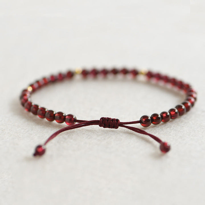 Pulsera de estabilidad con cuentas doradas y granate natural con Buddha Stones